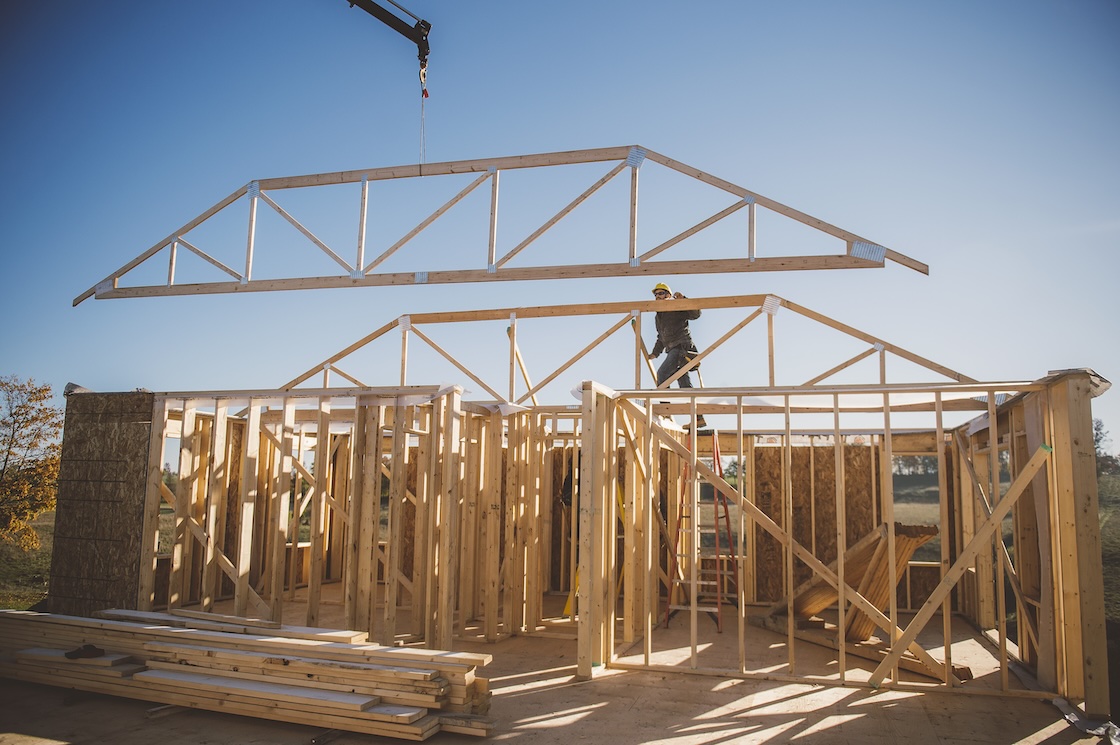 Crane positioning frame over building